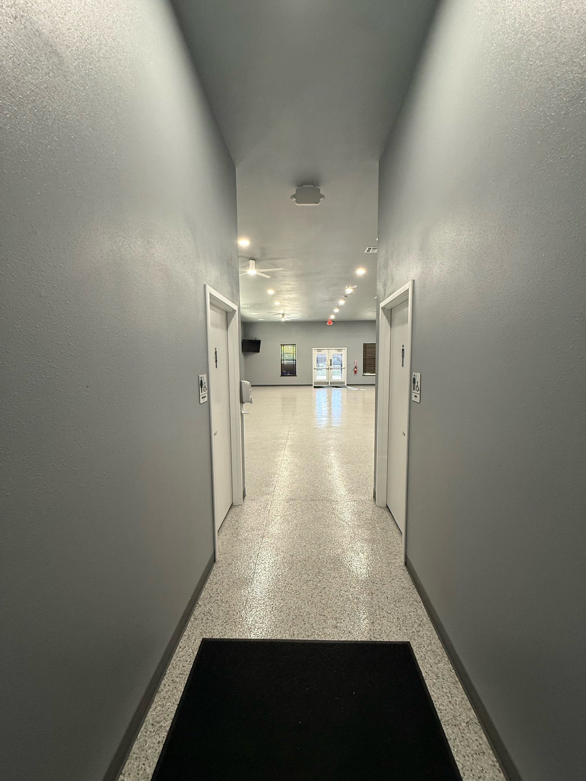 Hallway looking into the Community Center with restroom doors on both sides