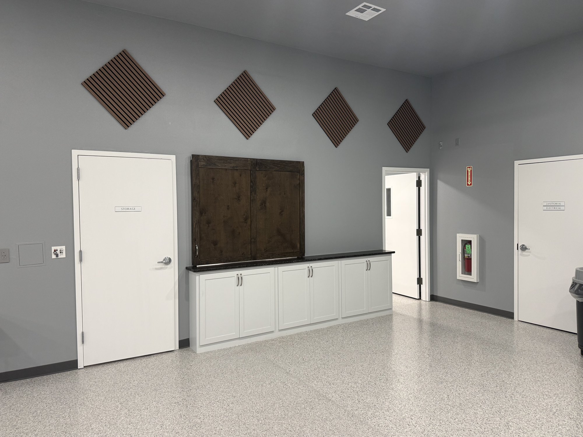 Service counter, storage door, and acoustic panels in the Community Center