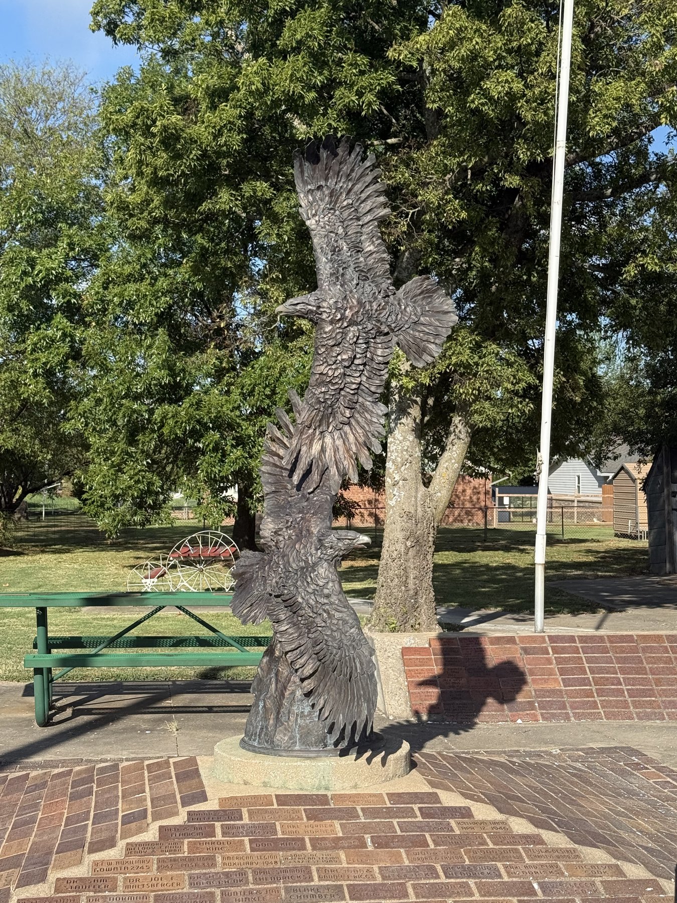 Eagle sculpture above a courtyard of commemorative memorial bricks