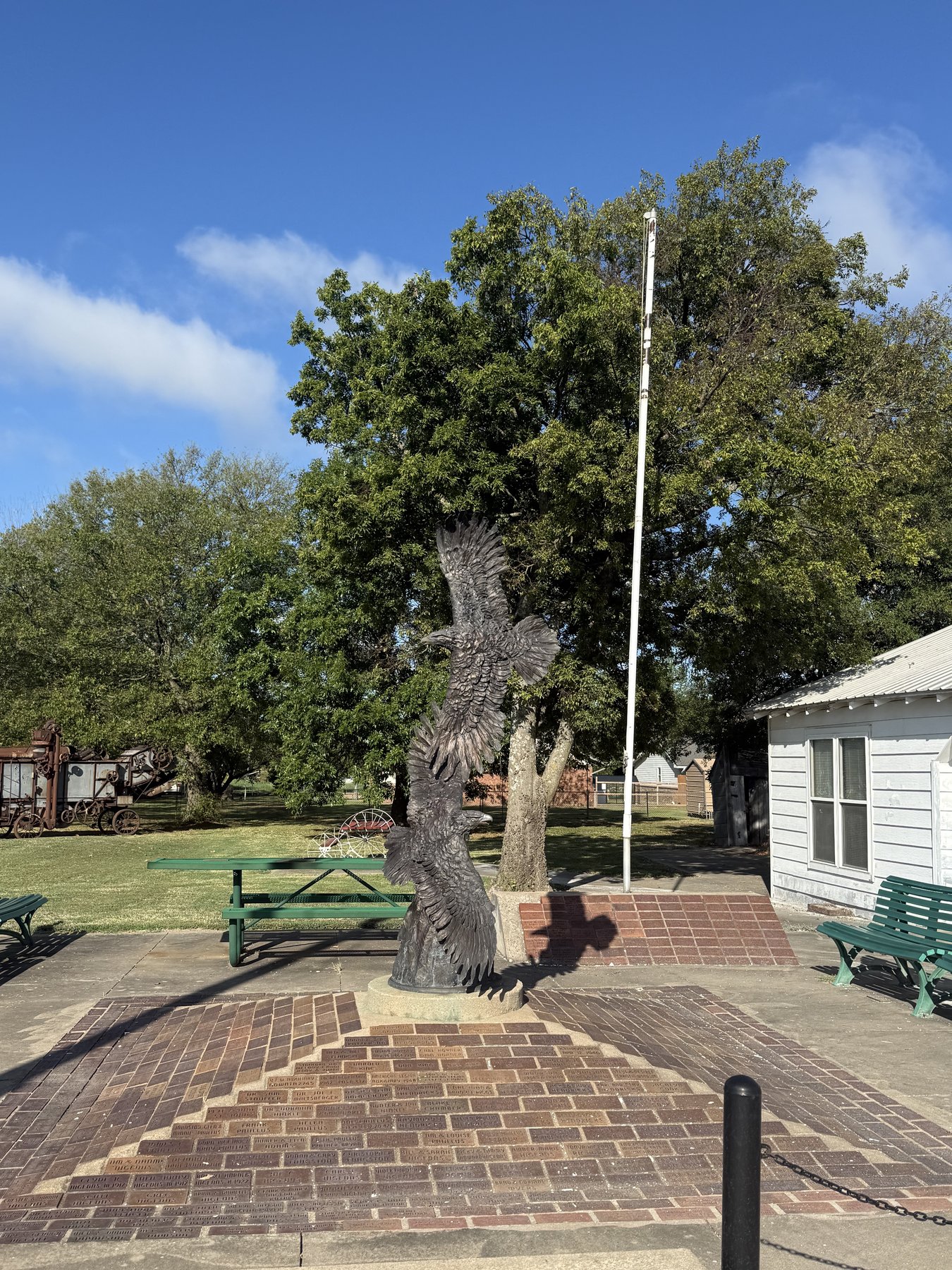 Eagle sculpture with the side of the museum building and a flagpole