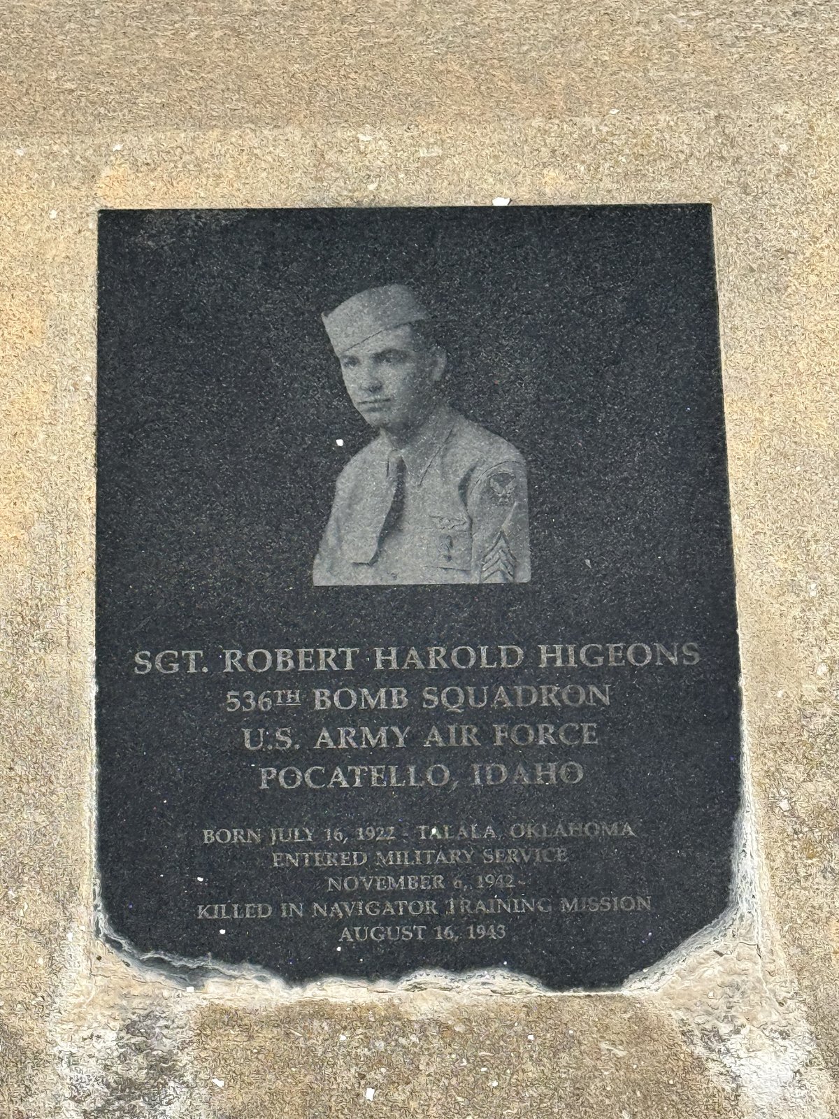 Granite memorial plaque with an etched portrait of Sgt. Robert Harold Higeons in Army Air Force uniform