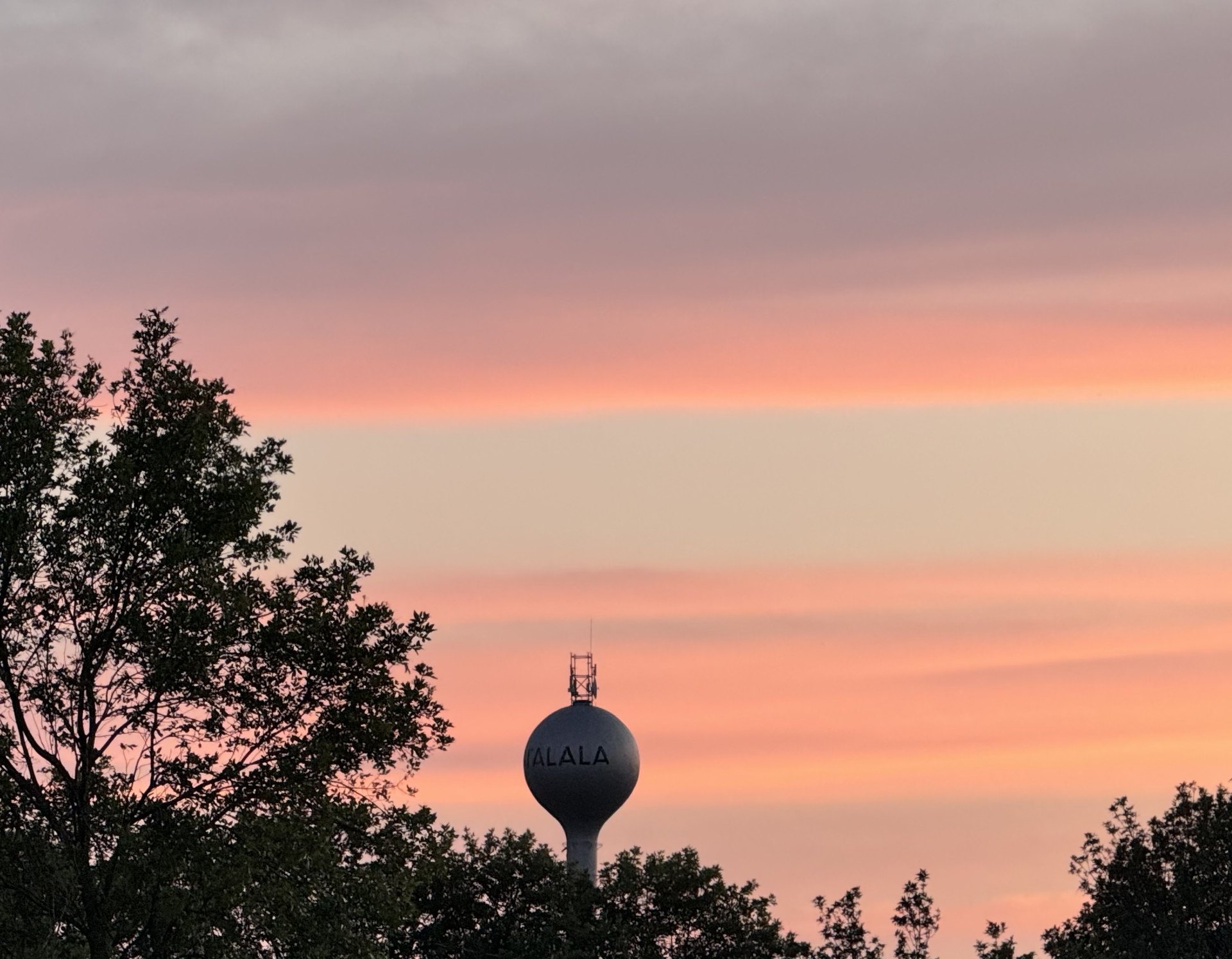 Talala water tower at sunset, with TALALA lettered on the tank
